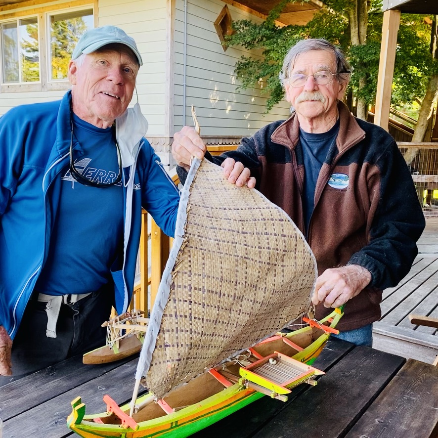 2021: Bruce Matlack with John Speer, exploring the Polynesian influences in windsurfing, highlighted by Speer's Hawaiian outrigger boat model.