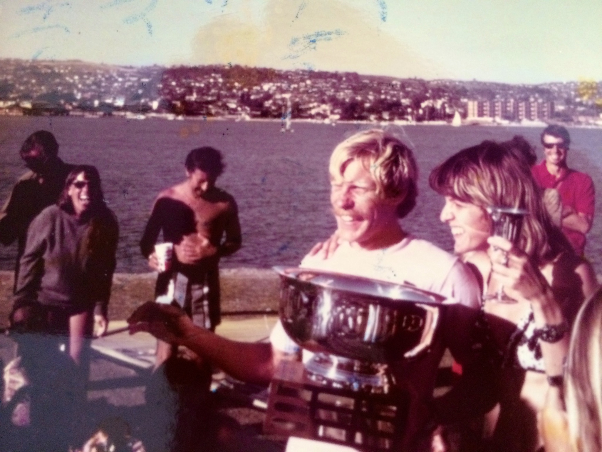 Bruce Matlack, alongside Markie, rejoicing as the first USA National Windsurfing Champion at Mission Bay, 1972, with Rick and Polly Pratt witnessing the historic moment.