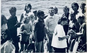 Late 1970s black and white photo at Huntington Lake with windsurfing pioneers: Bruce and Markie Matlack, Hoyle Schweitzer, Teddy Schweitzer, and others, commemorating their collective contribution to the sport.